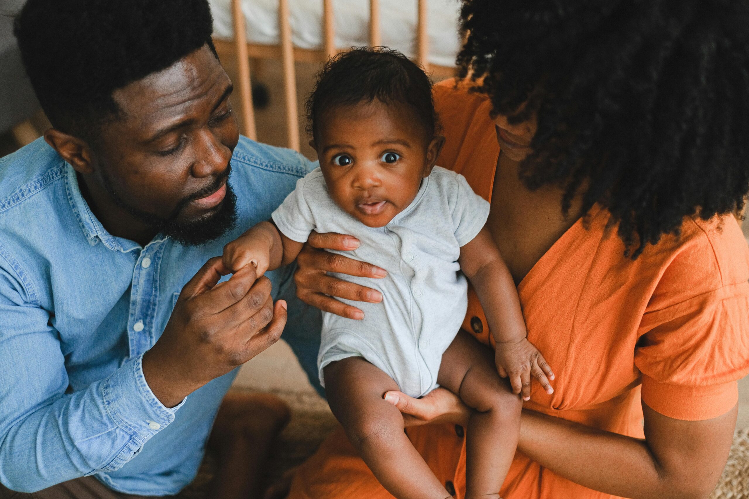 What to do Immediately if Suspect Autism in Your Child (0–3 YEARS) Loving parents holding adorable baby in a warm, intimate home environment.