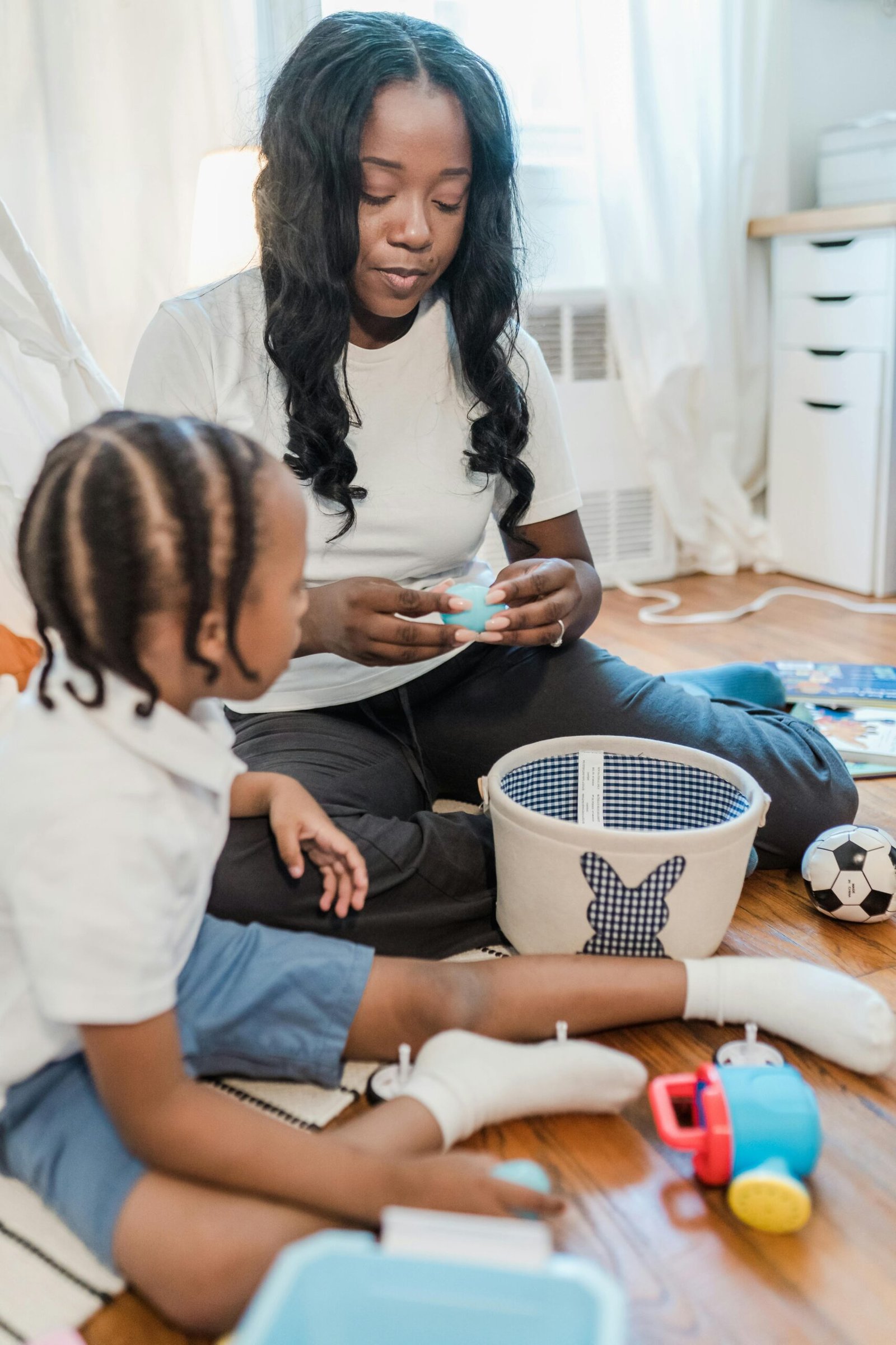 Sensory Seeking vs Sensory Avoiding: Understanding the Difference A mother and her young son play with toys together in a warm, cozy indoor setting.