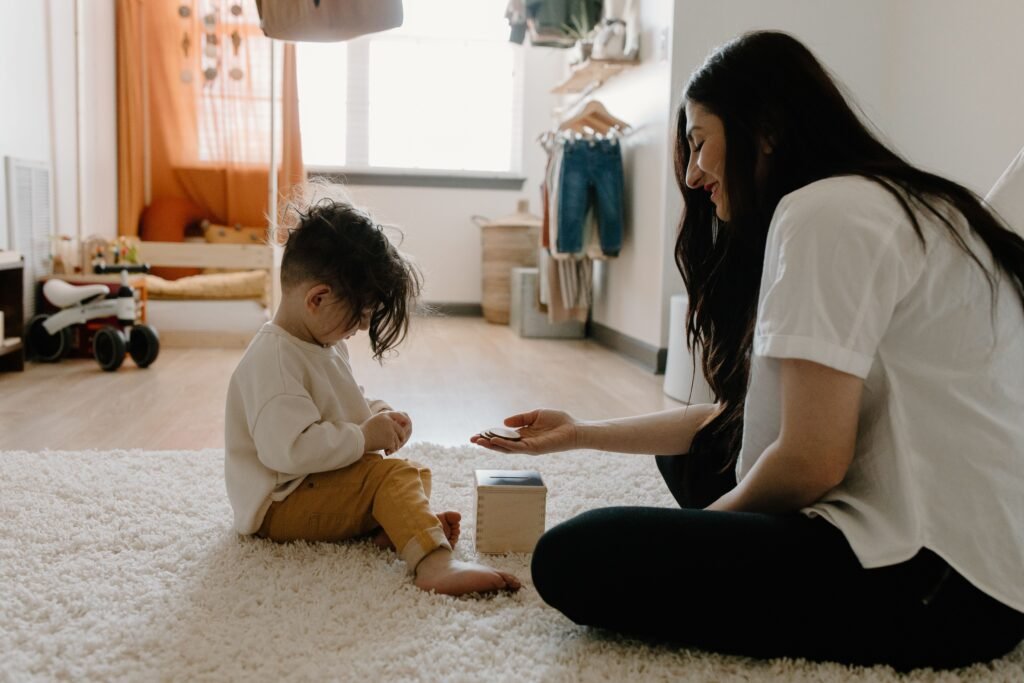 Sensory Seeking vs Sensory Avoiding: Understanding the Difference A mother and child play with an educational toy in a cozy indoor setting.