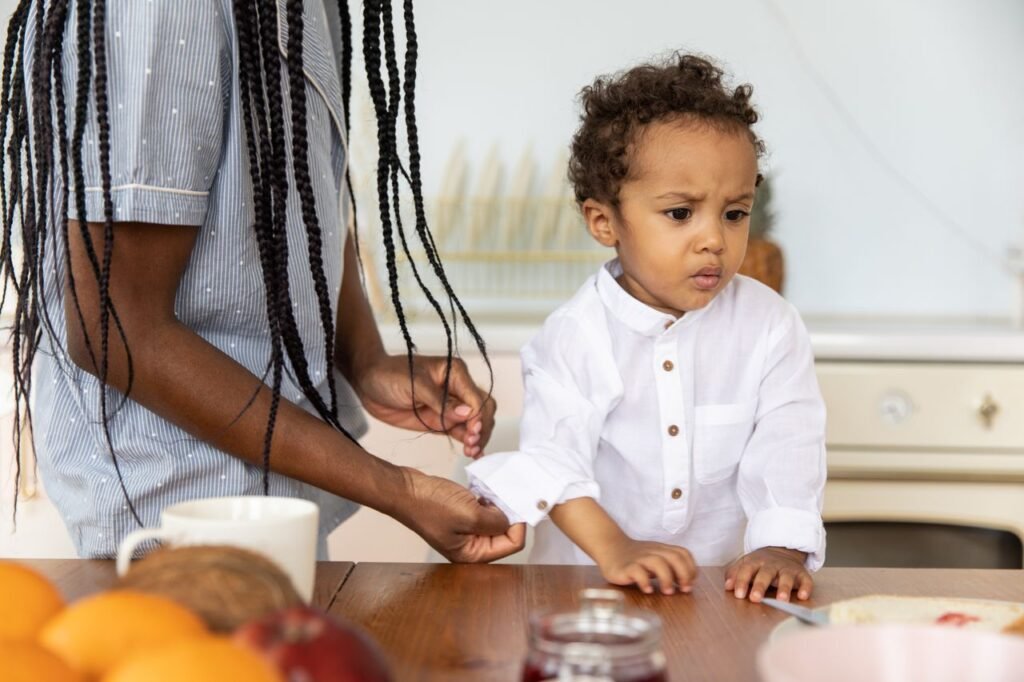 Mother and child enjoying a moment at the dining table indoors.